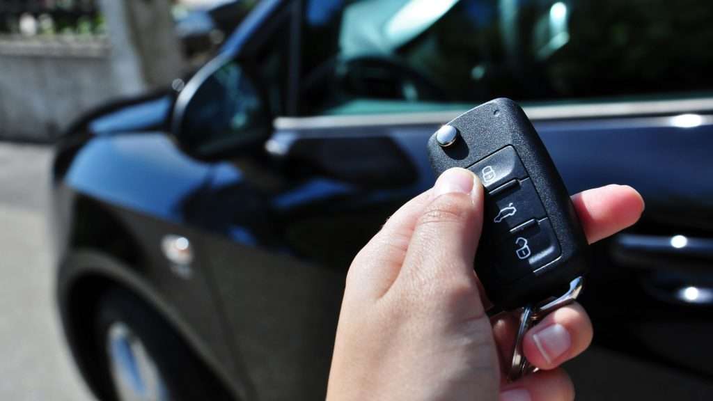 A user holding a transponder key. electronic keys are the most common car keys.