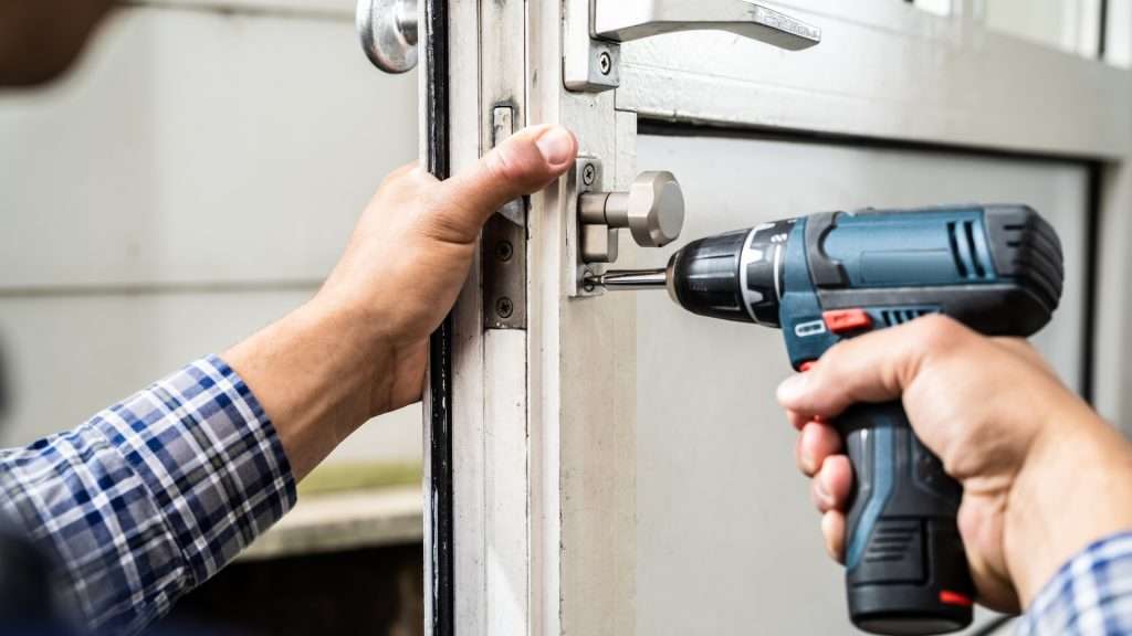 A residential locksmith installing a new door lock