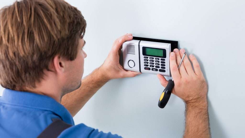 A commercial locksmith installing a digital lock