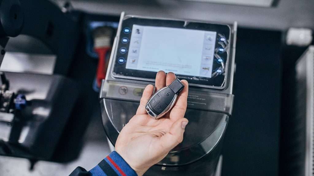 A car key fob held by a commercial locksmith