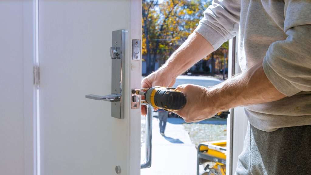 A locksmith installing a lever lock on a commercial door