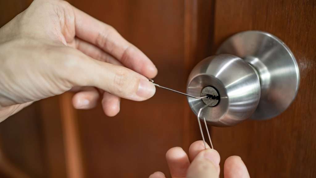 A locksmith performing lock picking service