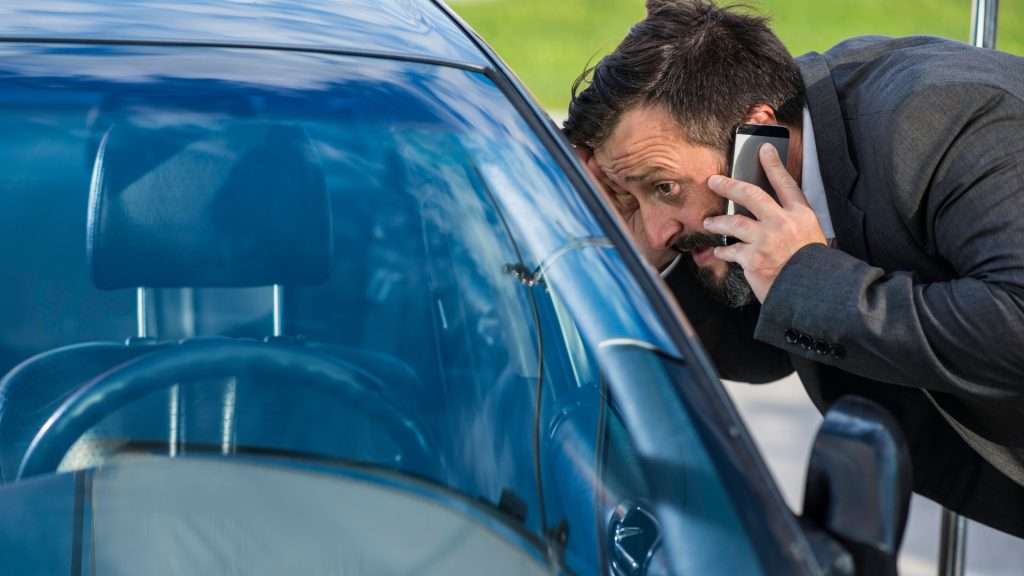 A driver calling a car locksmith because of a lockout