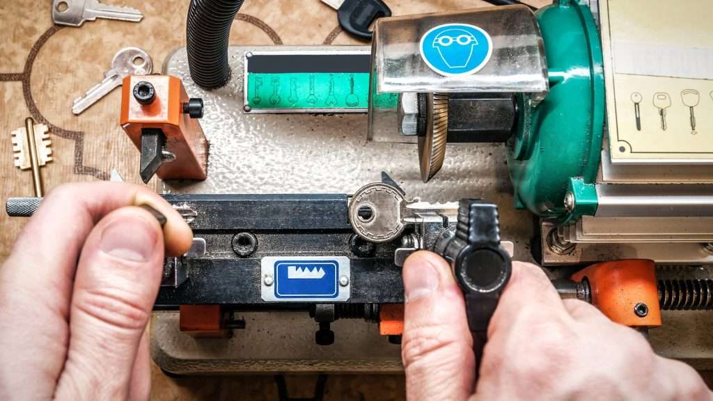 A locksmith performing professional key cutting