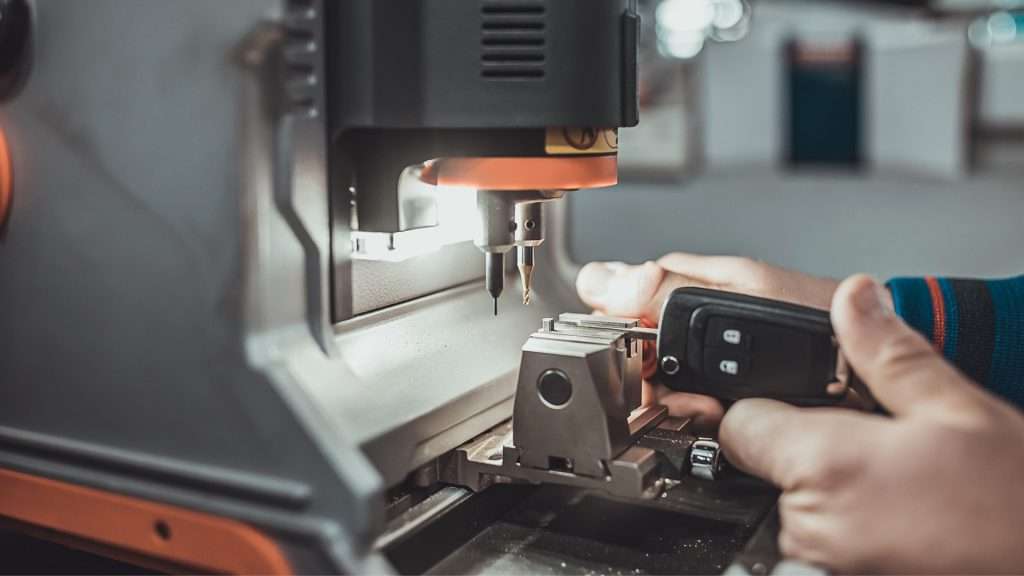 A car locksmith cutting a spare key