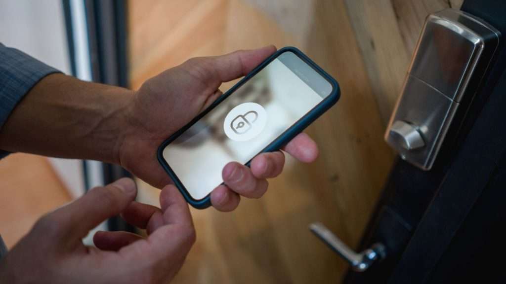 A user using his smartphone to unlock a smart lock