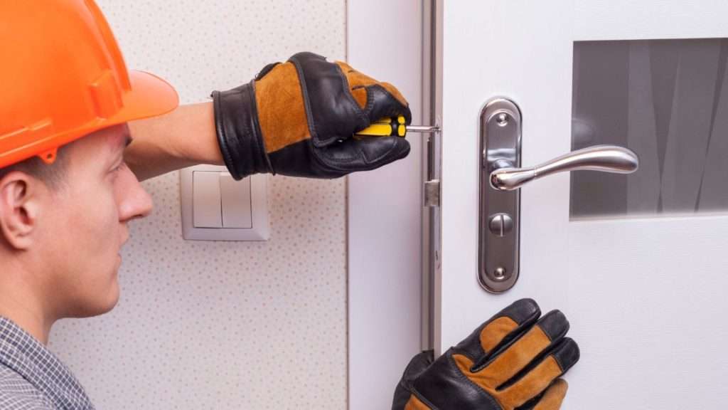 A technician doing professional lock installation
