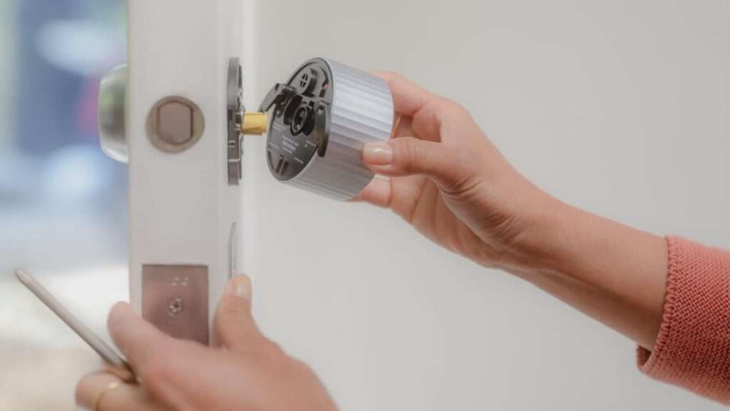 A homeowner installing a lock on their front door