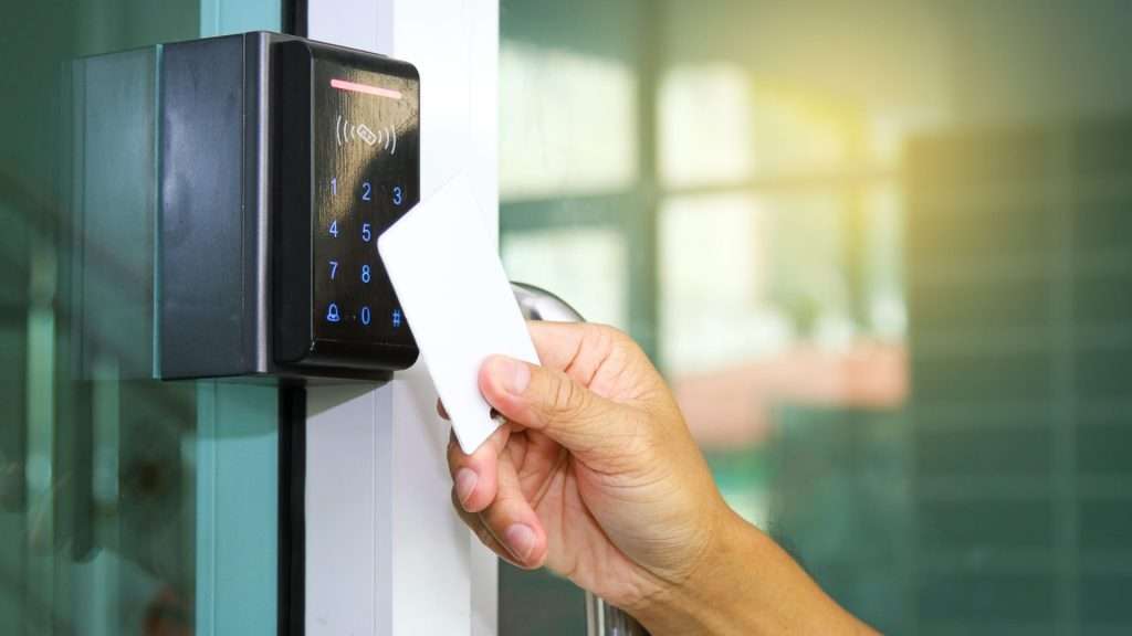 A user tapping a key card on one of their storefront locks