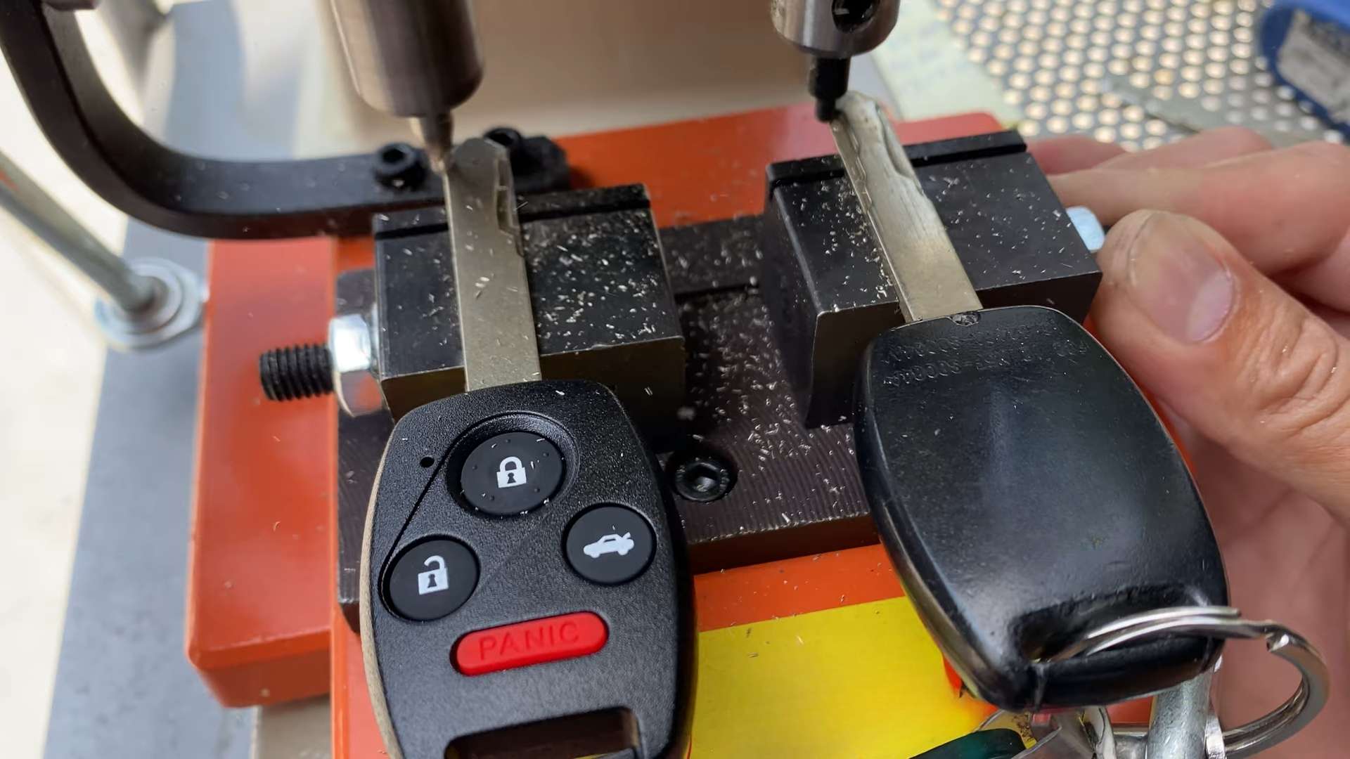 A locksmith duplicating Ford keys