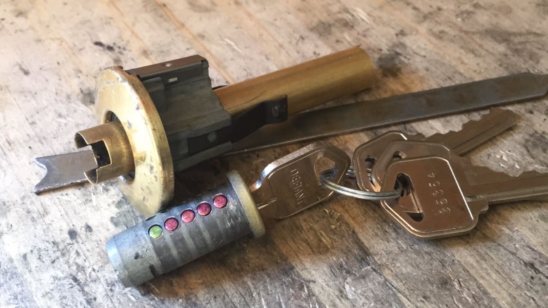 Close-up of commercial rekeying lock parts and keys.