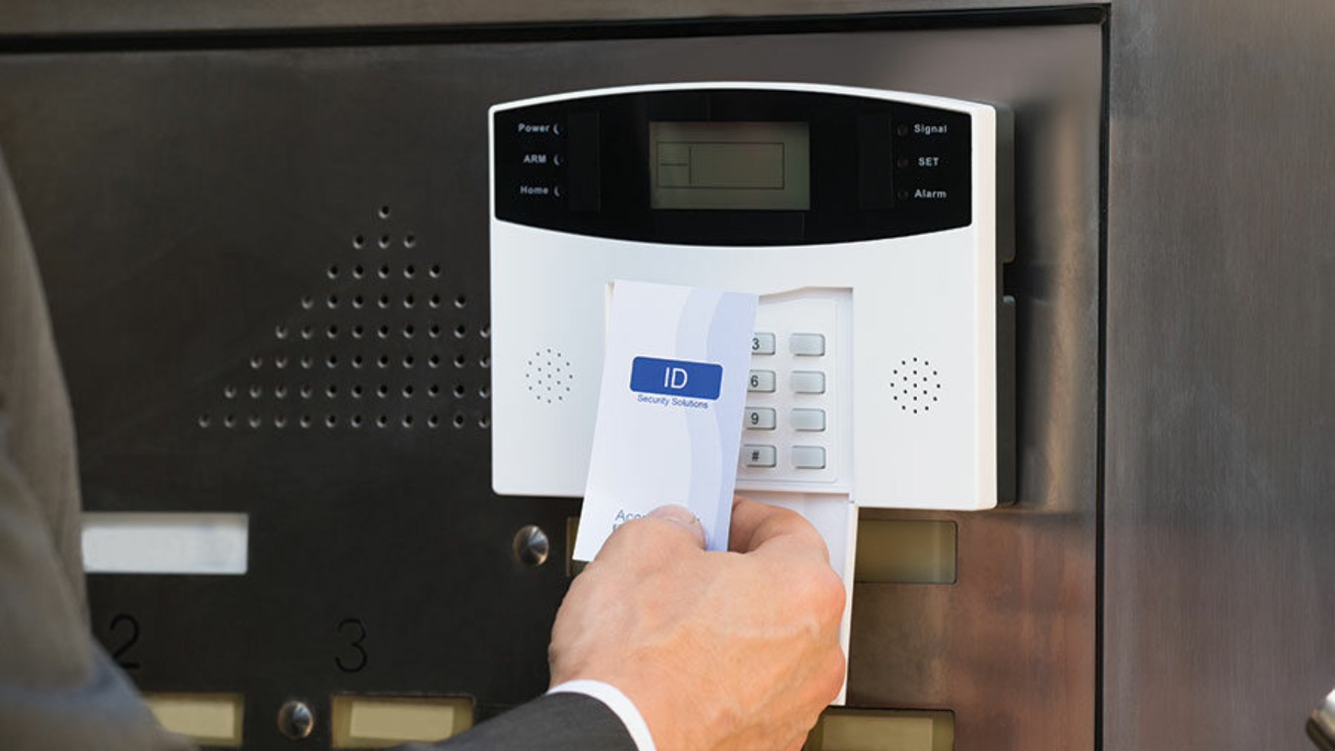 Employee unlocking the door with a key card access system.